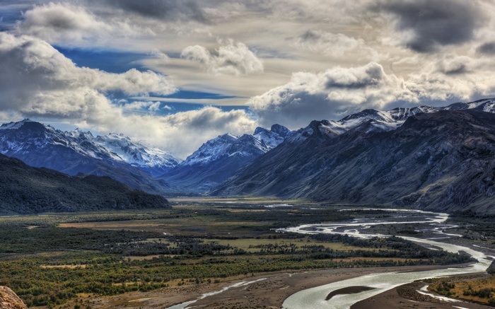 Winding River Valley Between Snow-Capped Mountains