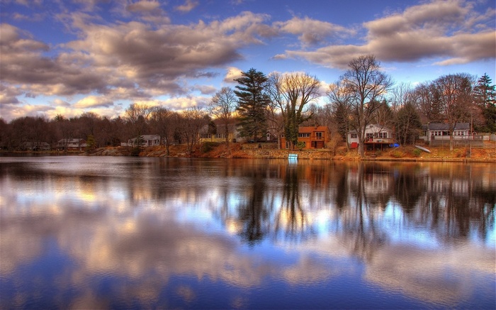 Houses on a lake shore with reflections