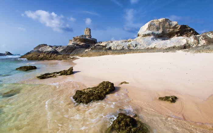 Rocky beach with white sand and turquoise water