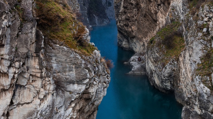 Deep blue river flowing through a rocky canyon