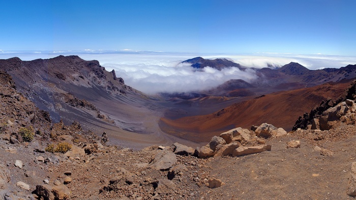 Volcanic crater landscape with clouds and mountains