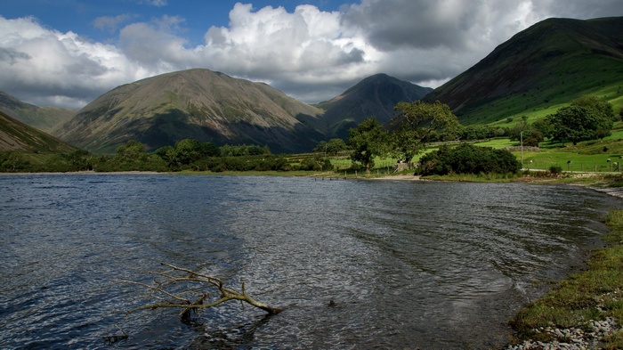 Lake and mountains under a cloudy sky