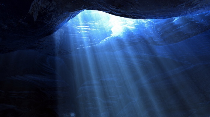 Sunlight beams through underwater cave