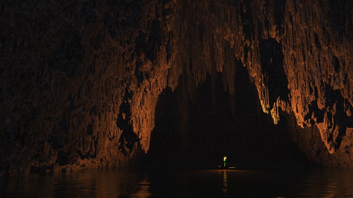 Person in boat in a dark cave with stalactites