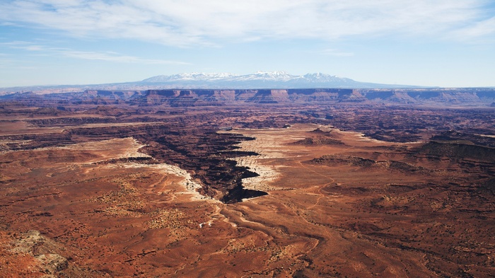 Canyonlands National Park with snow-capped mountains in distance
