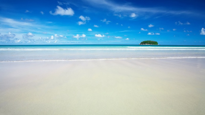 Tropical island beach with blue sky and ocean