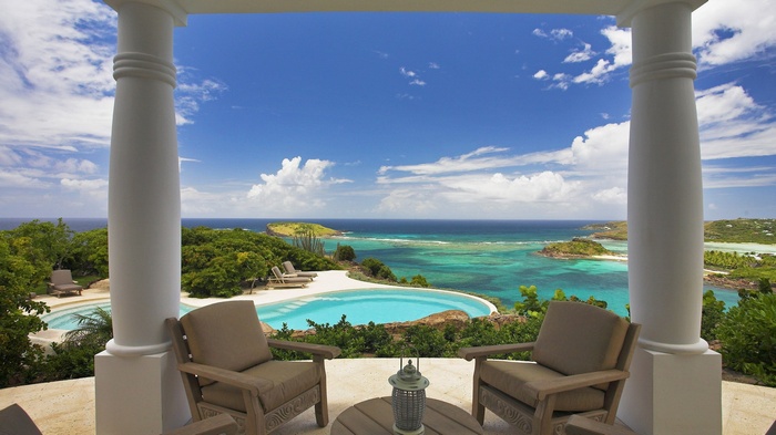 Luxury villa with infinity pool overlooking turquoise ocean