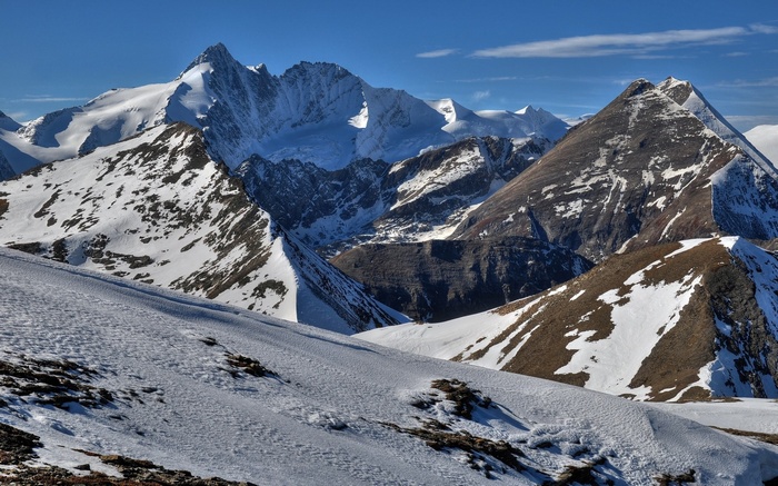 Snow-covered mountains under a clear blue sky