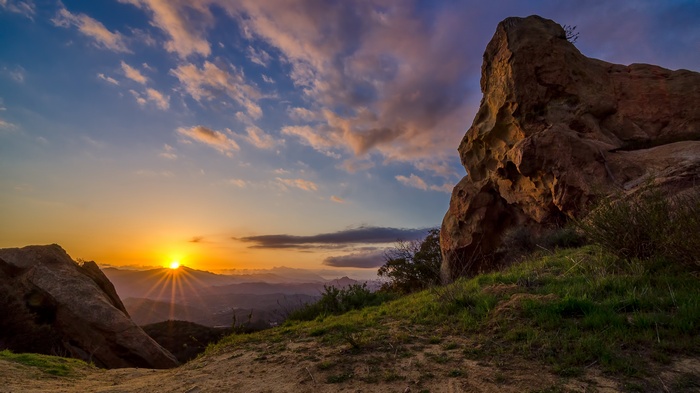 Sunset over mountains with rock formations