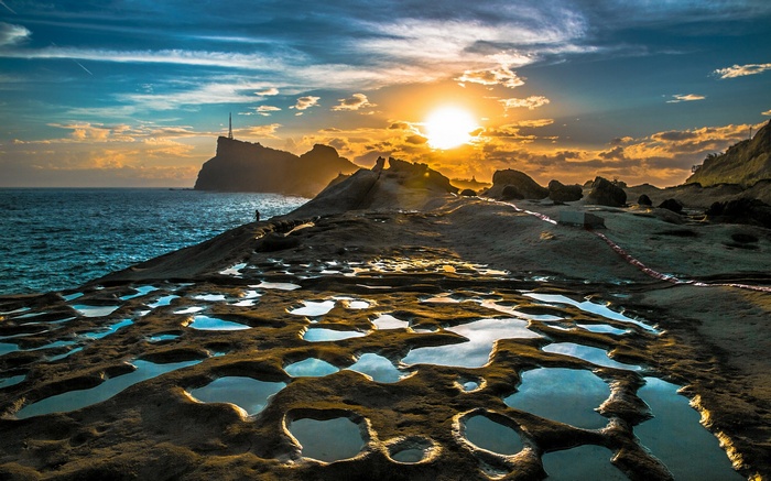 Rocky coastline with tide pools at sunset