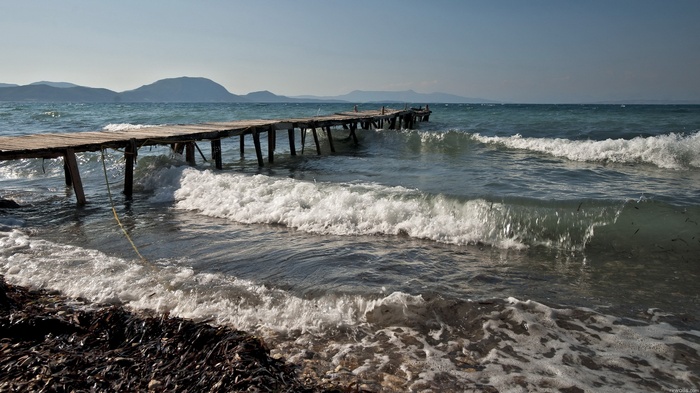 Wooden pier over the sea with waves