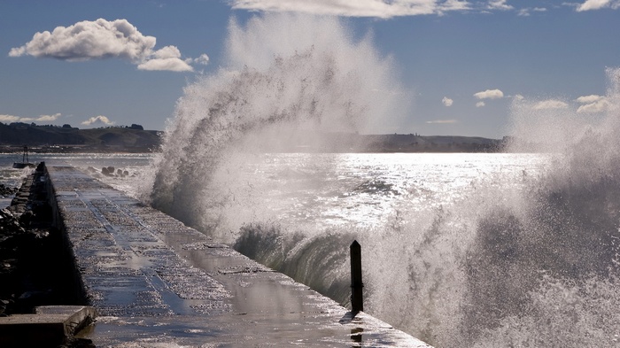Wave crashing on a concrete pier