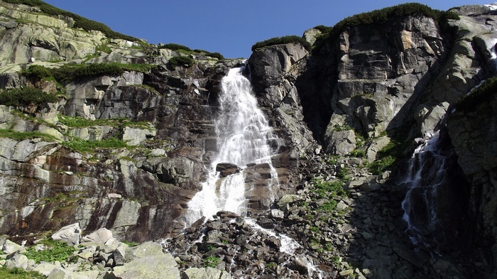 Waterfall cascading down a rocky mountain slope