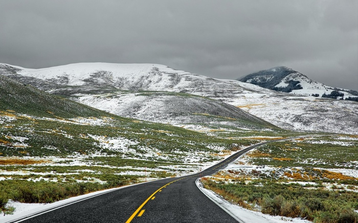 Winding Road Through Snowy Mountains