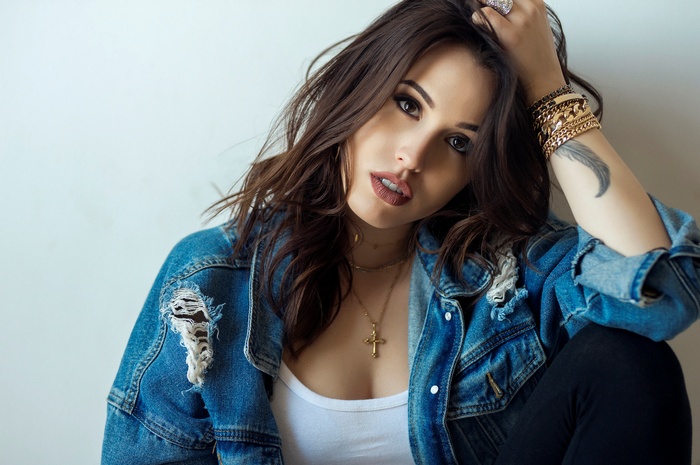 Woman with denim jacket and jewelry