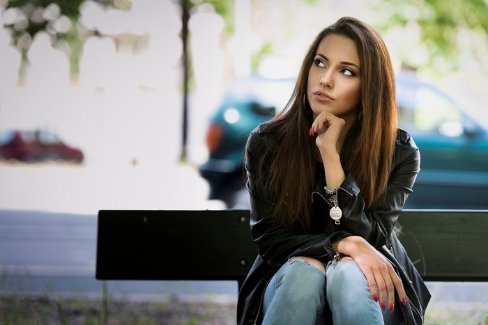 Brunette woman with long straight hair looking away