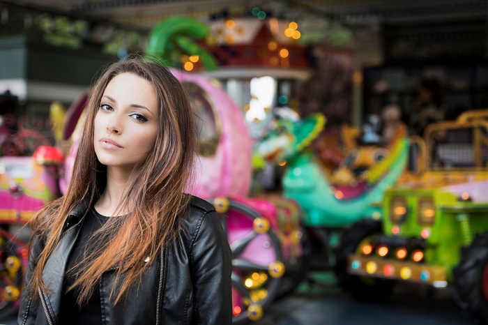 Woman in leather jacket at amusement park