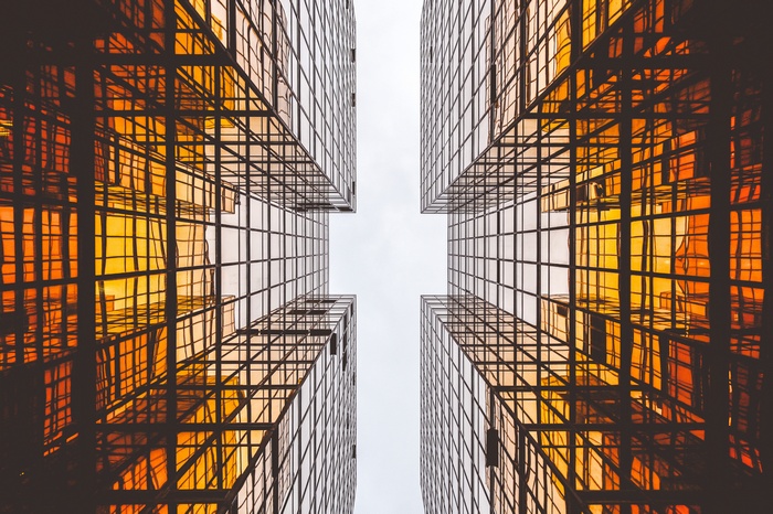 Looking up at golden glass buildings
