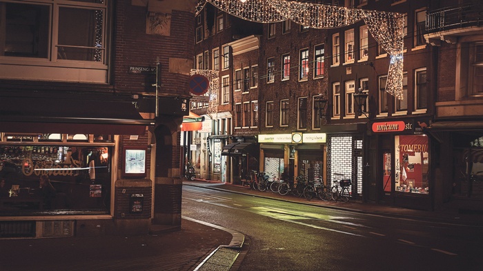Night street in Amsterdam with lights and shops