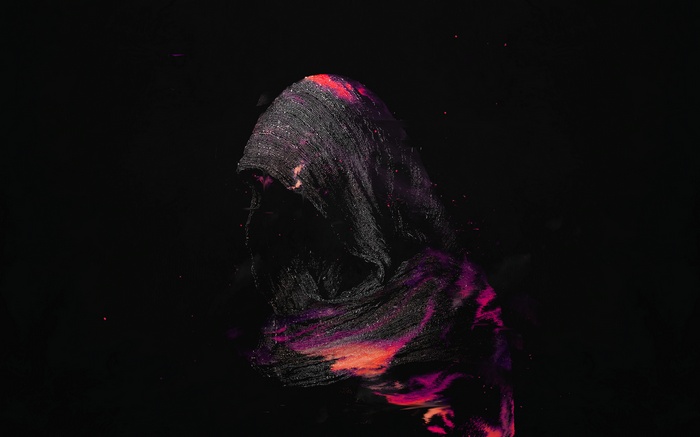 Person in dark hood with colorful powder
