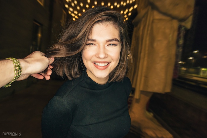 Woman smiling, hair being held, Jonas Svidras