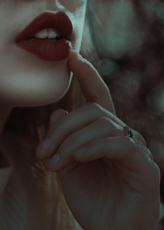 Woman with red lipstick biting her lip