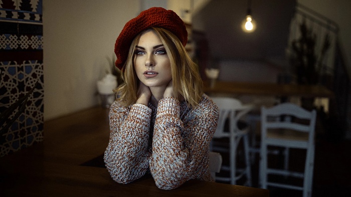 Woman wearing a red beret and sweater