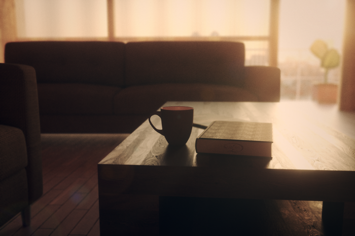 A coffee mug and book on a coffee table
