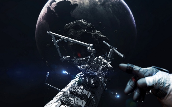 Astronaut reaching towards asteroid near International Space Station and Earth