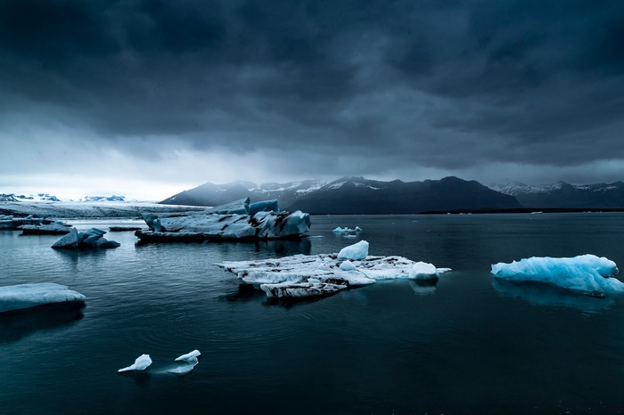Icebergs in Jökulsárlón, Iceland under stormy clouds