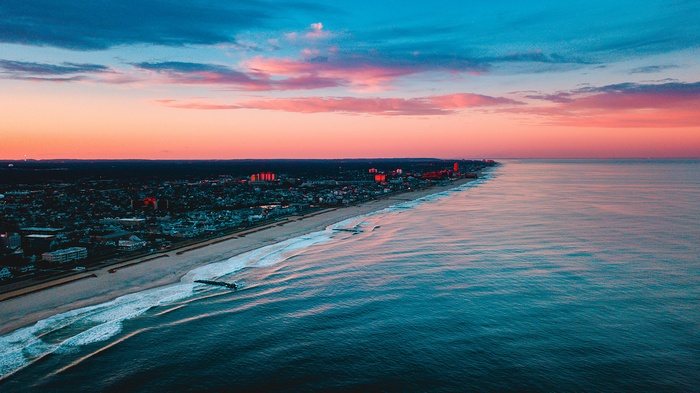 Sunset over a coastal city and the ocean
