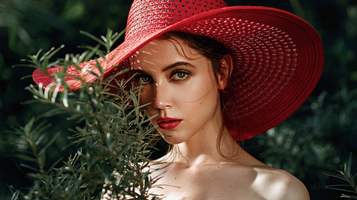Woman in red hat with red lipstick and plants