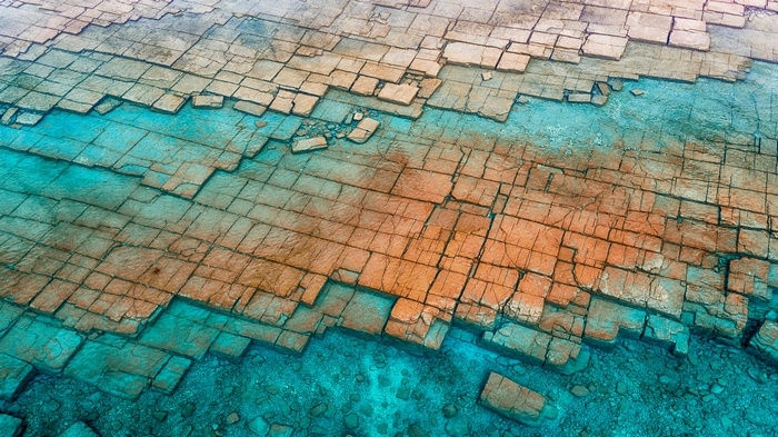 Patterned rock formations in turquoise water