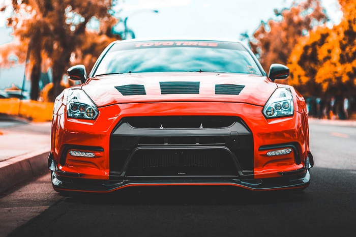 Red Nissan GT-R sports car with Toyo Tires banner
