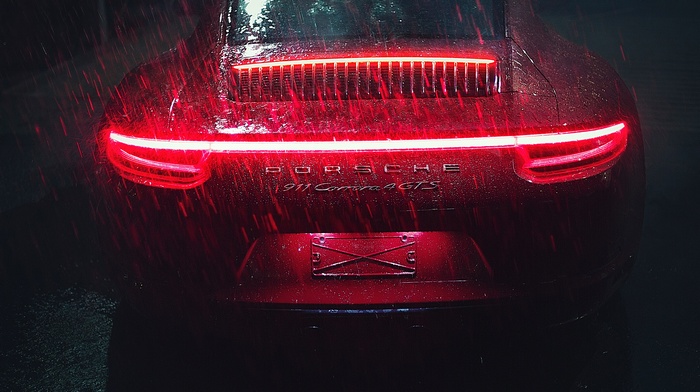 Red Porsche 911 Carrera GTS in the rain