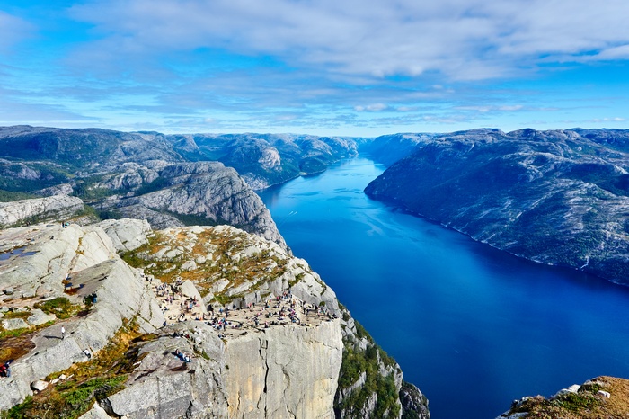 Preikestolen, Norway: Tourists on a cliff overlooking a fjord
