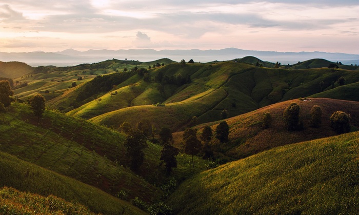 Rolling hills and mountains in Thailand at sunset