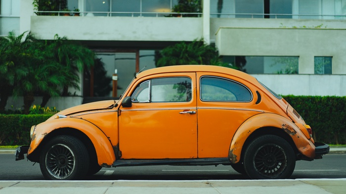 Orange Volkswagen Beetle parked on street