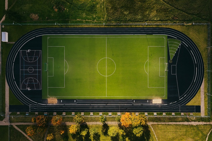 Aerial view of a sports stadium with soccer and basketball courts