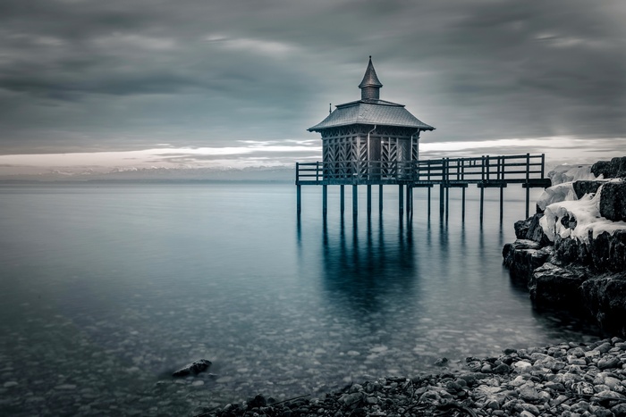 Wooden structure on stilts over water in winter