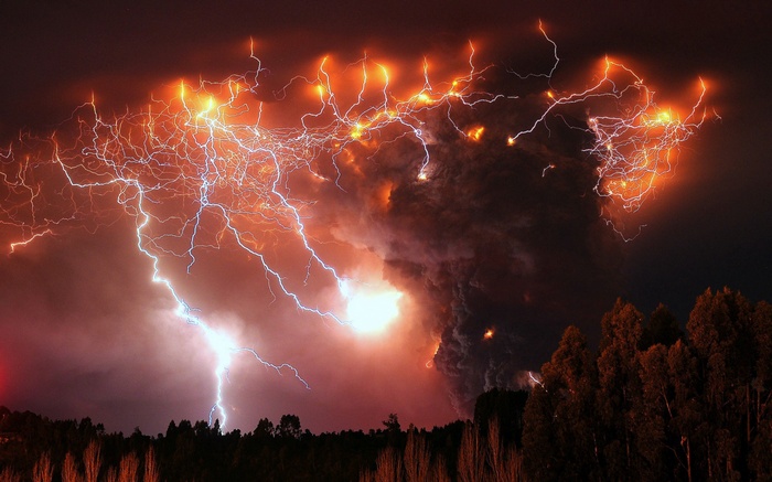 Lightning strikes over a volcanic eruption in Chile at night