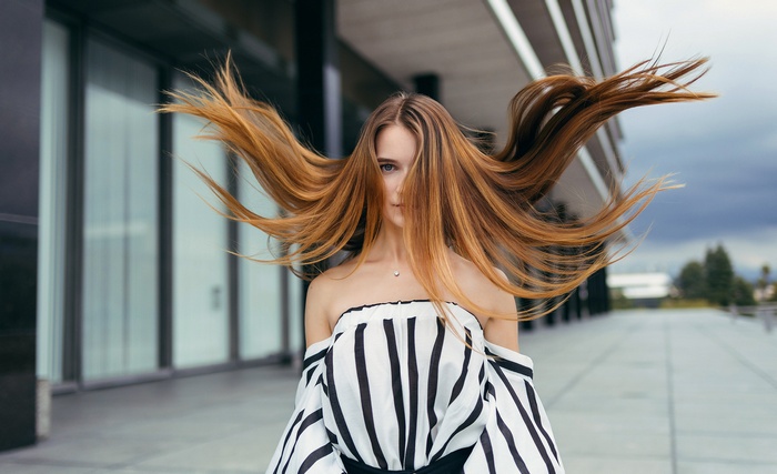 Woman with long blonde hair blowing in the wind