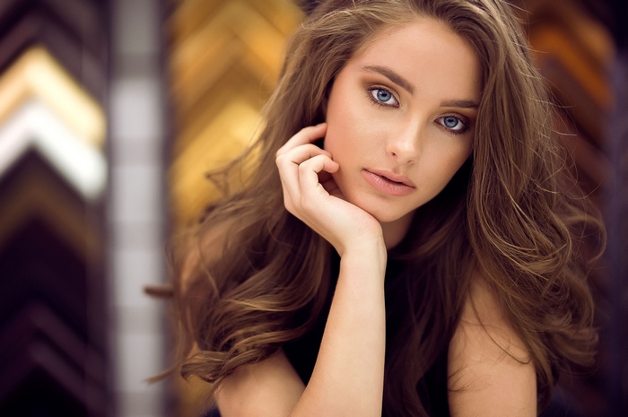 Portrait of a woman with blue eyes and pink lipstick