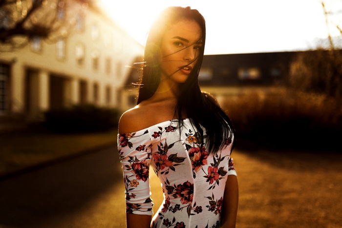 Woman with black hair in a floral dress