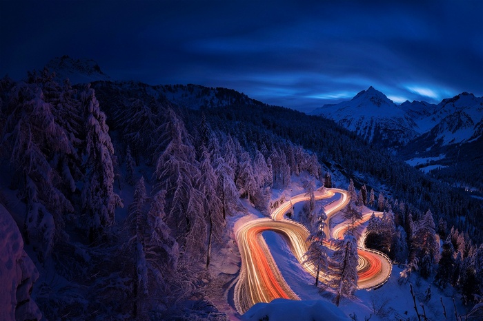 Winding mountain road at night in winter
