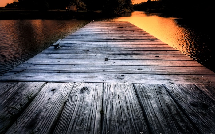 Wooden pier on a lake at sunset