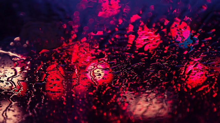 Red lights and water drops on glass