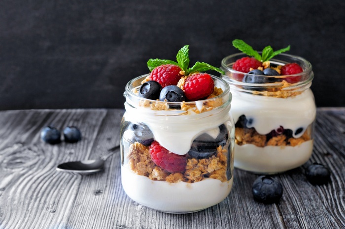 Yogurt parfaits with berries and granola in jars