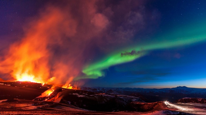 Volcano eruption under the Aurora Borealis