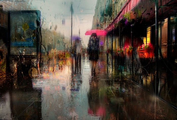 Rainy street in St. Petersburg with people and umbrellas